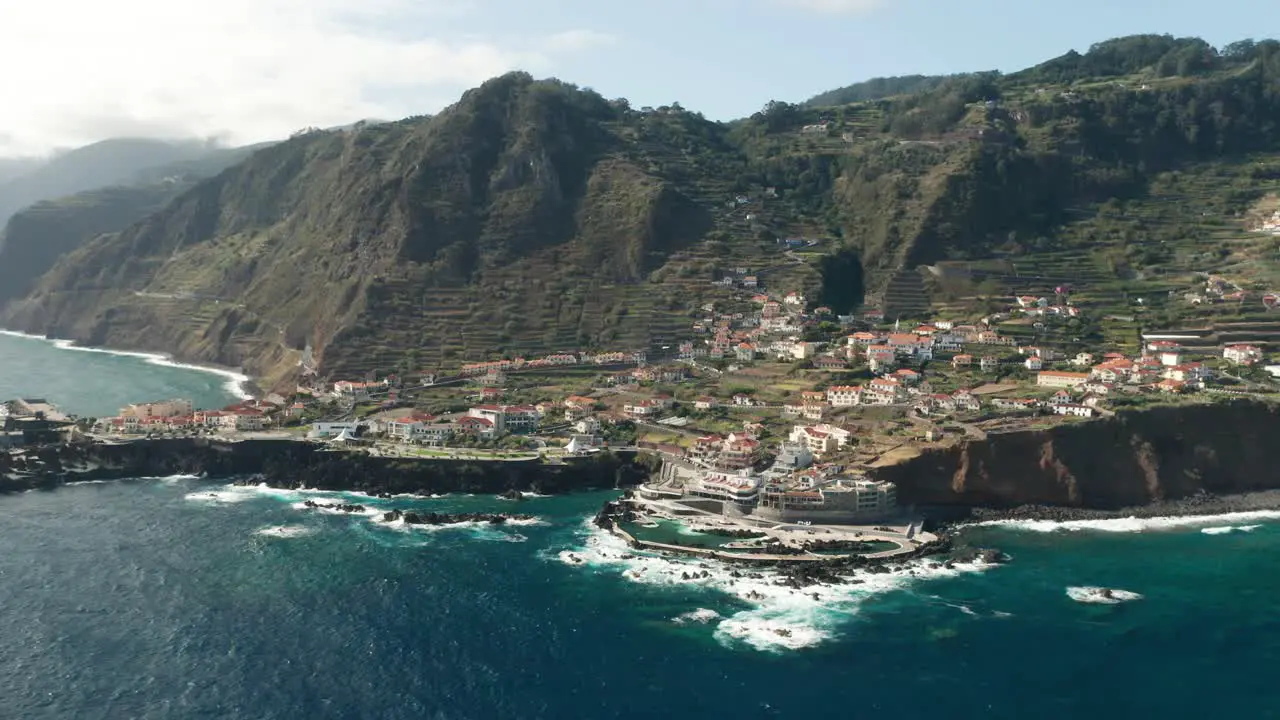 Scenic coastal area with steep cliffs at small village of Porto Moniz aerial