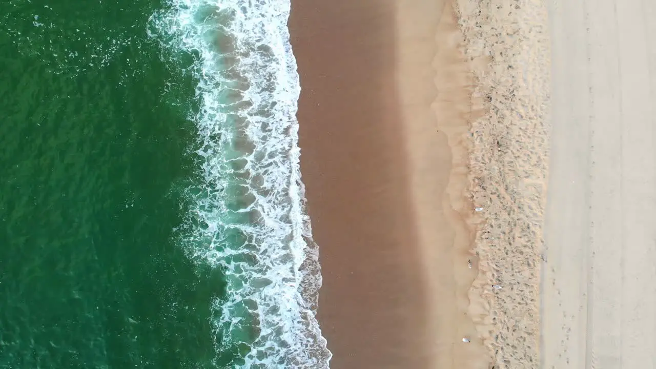 High angle aerial view of clear turquoise sea and waves