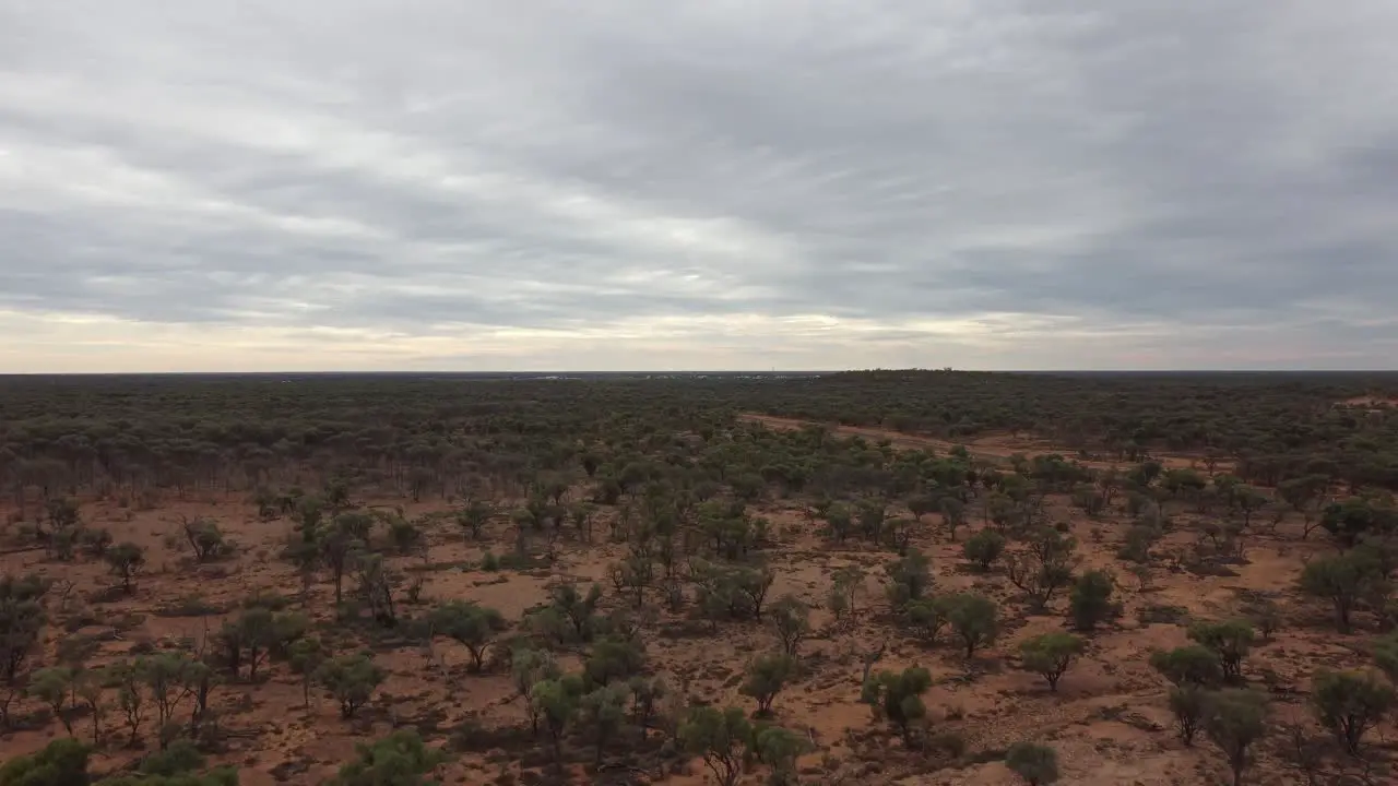 Drone ascending over the Australian bushland revealing a rough landscape