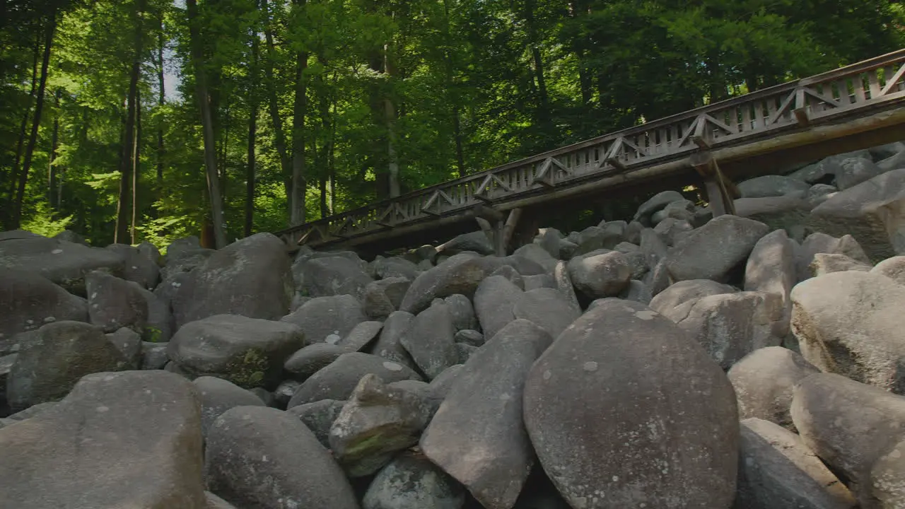 Felsenmeer in Odenwald Sea of rocks with bridge Wood Nature Tourism on a sunny day pan shot