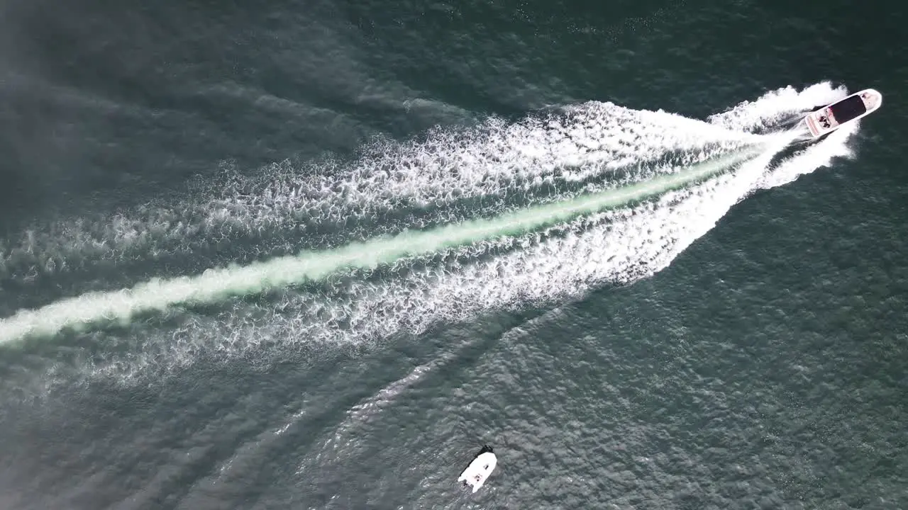 Top down shot of a yacht passing by in the ocean during summer in Pucusana Peru