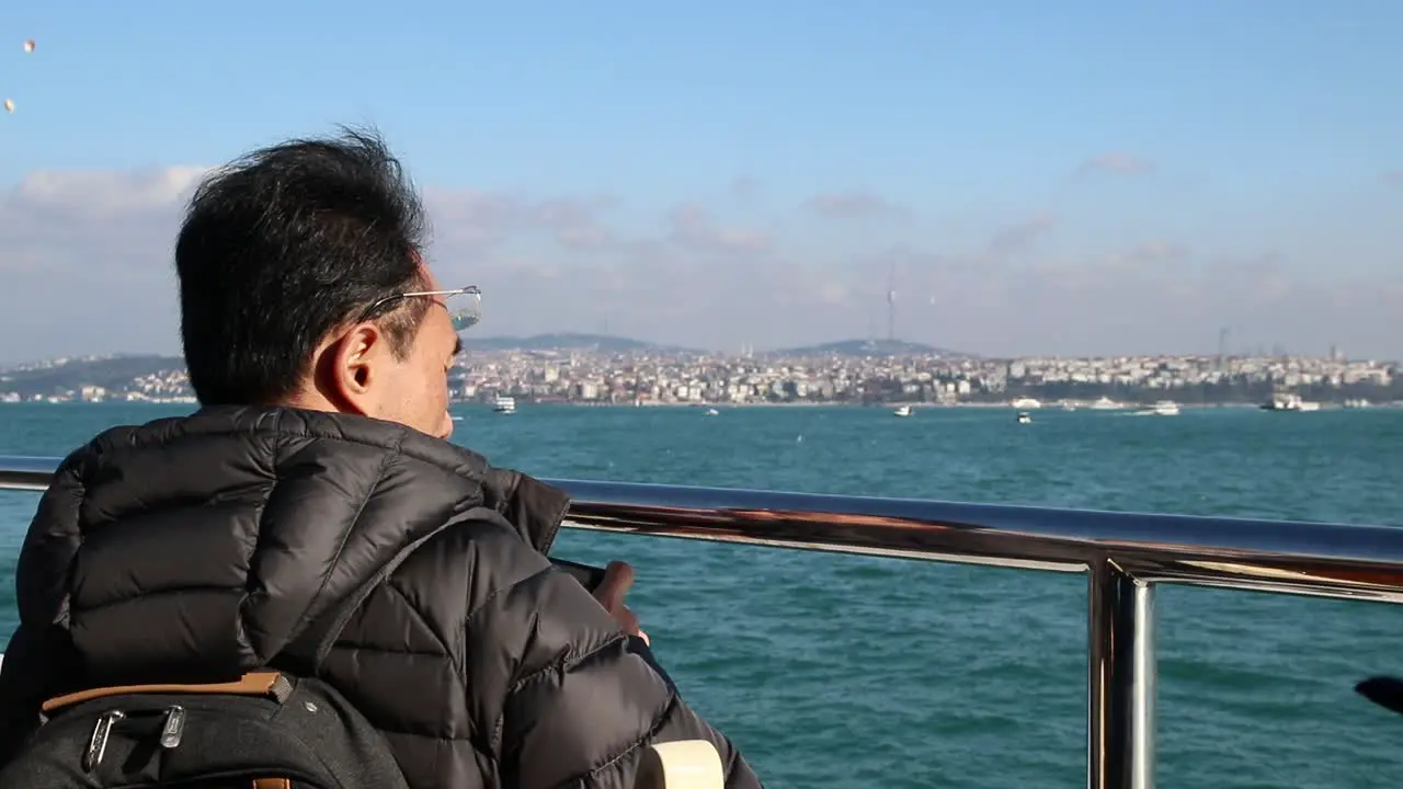 Man At The Seaside Using Smartphone To Take A Photo