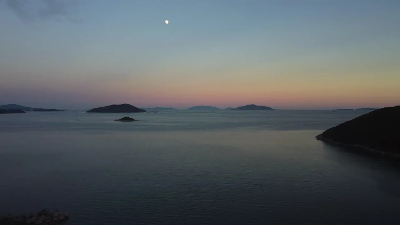 Late Evening Drone Shot Over the Sea with the Moon