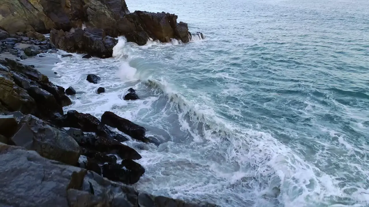 Ocean waves crashing on cliff rocks