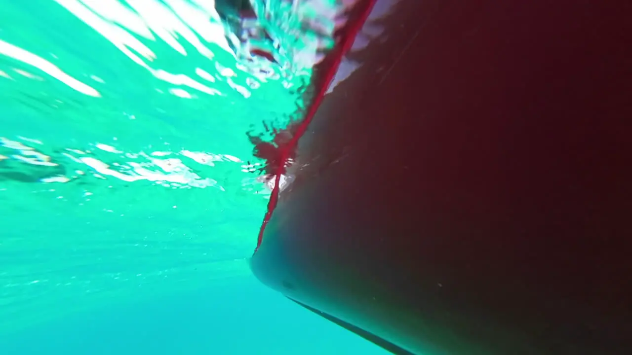 Under view of a boat full in a crystal clear sea water