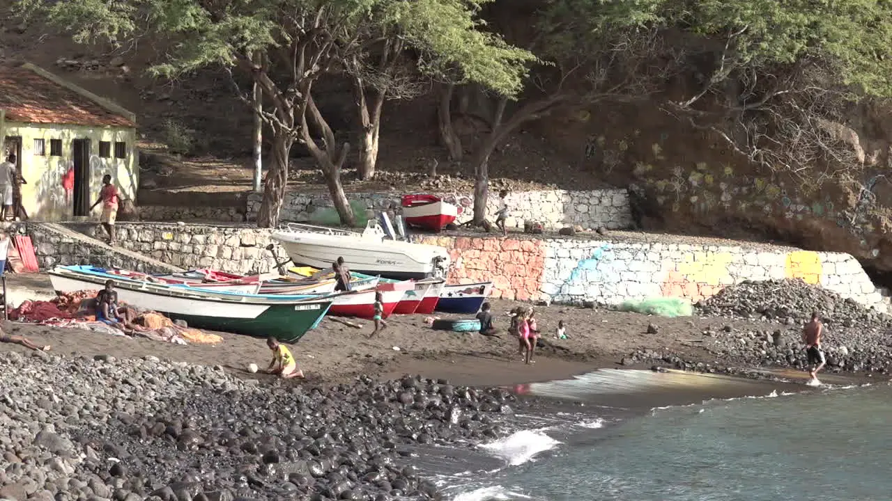 Children play on a beach in a Cape Verde Island African fishing village