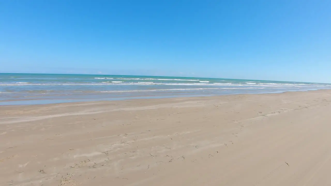 POV thru driver's window while on desolate beach on gulf side of South Padre Island Texas