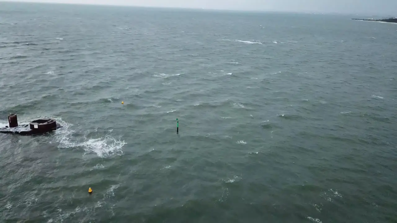 Drone aerial over ocean Melbourne wavy windy cloudy day ship wreck