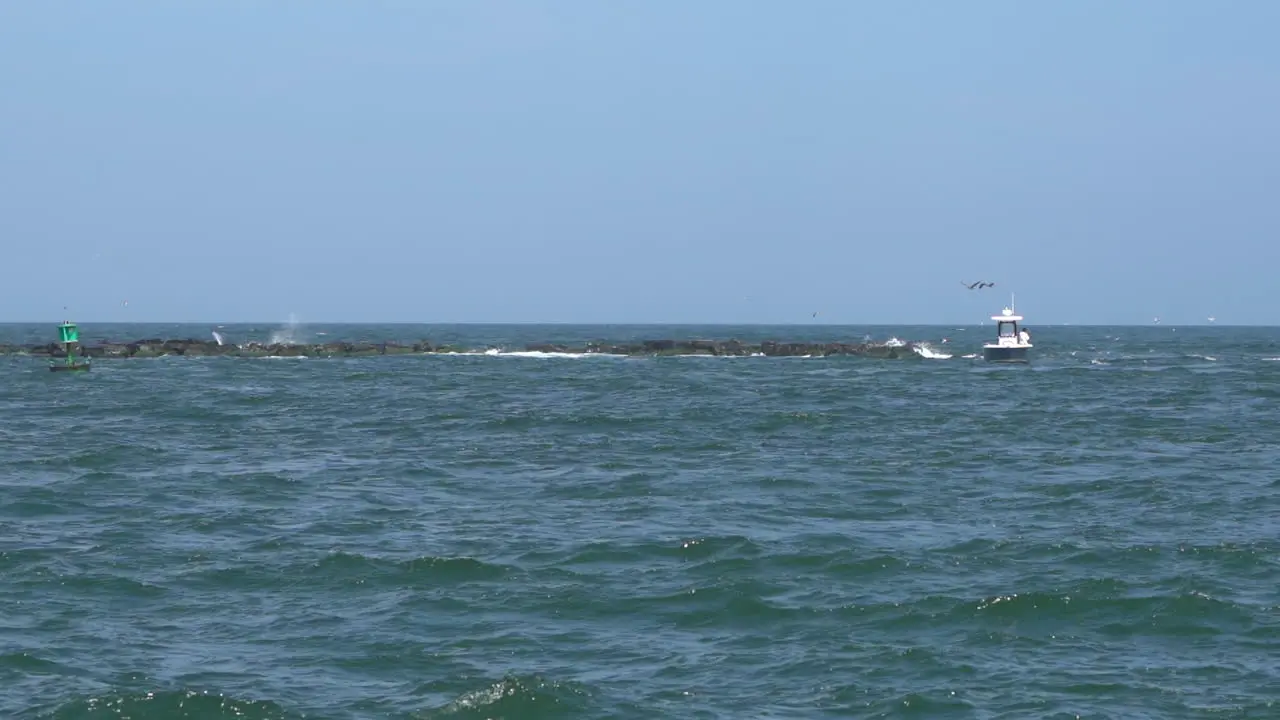 The ocean waves breaking in the rock jetty