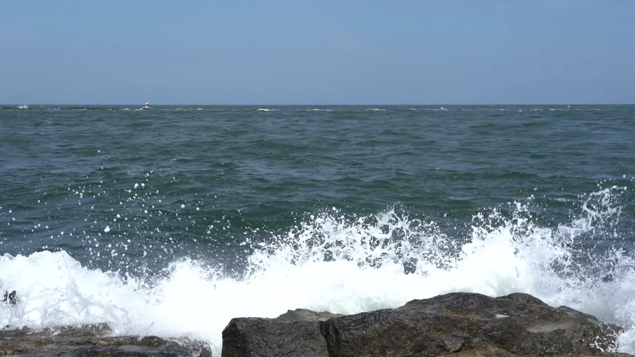 The waves from the ocean breaking over the rocks on the shore