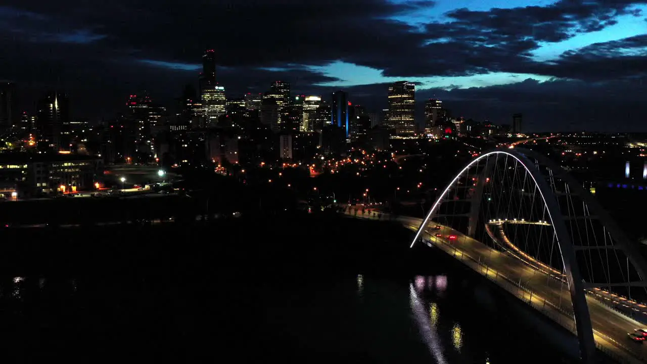 Aerial drone view of the Edmonton Walterdale Bridge over the North Saskatchewan River during a summer night and the downtown skyline in the background