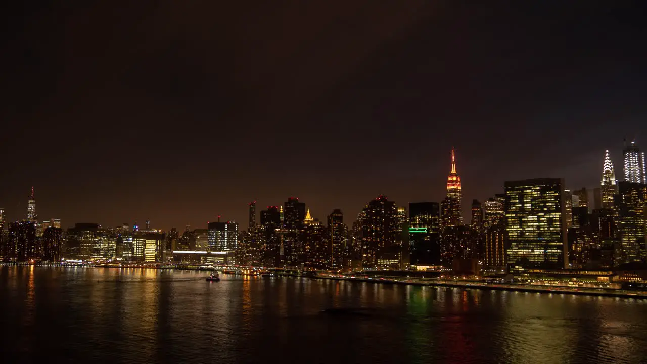 Time Lapse of Manhattan FDR Drive and East River between One World Trade Center and the Chrysler Building at dusk and night shot from Long Island City New York City