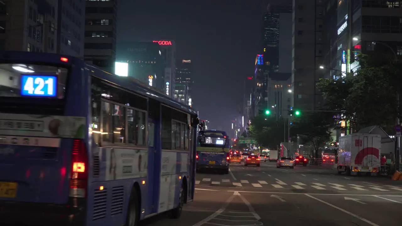 Busy urban main street of Gangnam buses and traffic at night static Seoul city South Korea