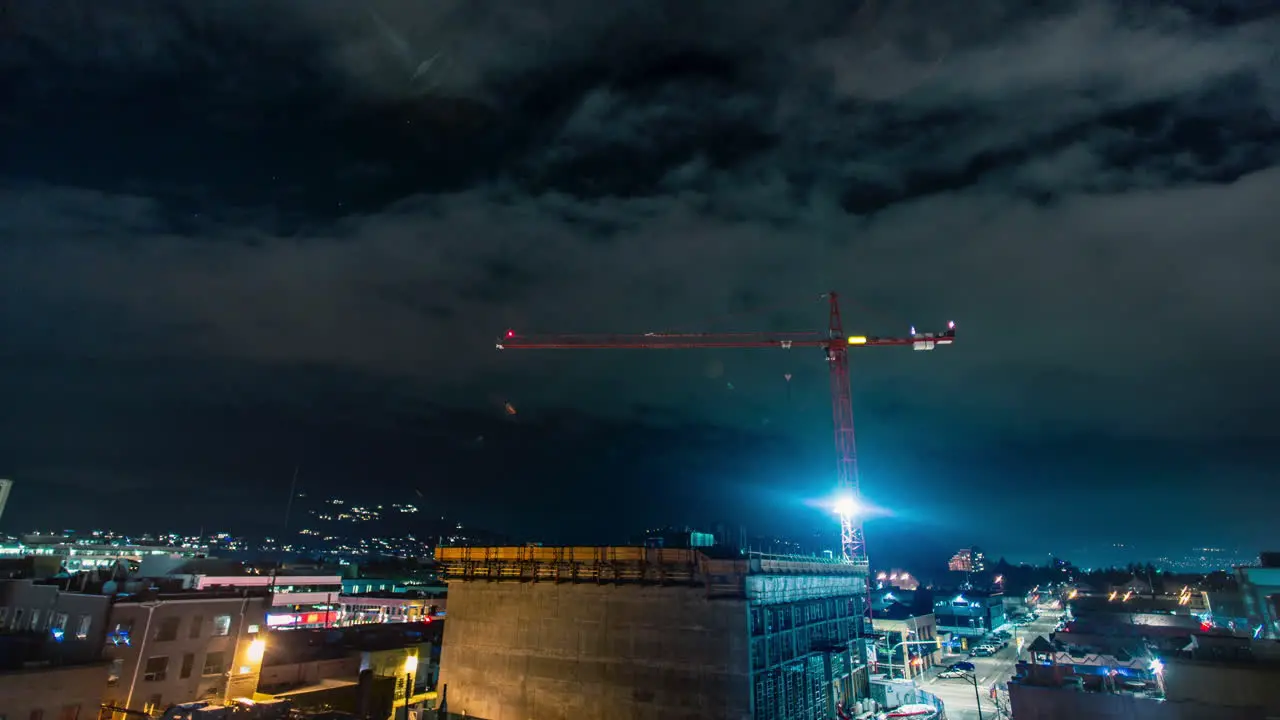 Night time time lapse of crane over developing downtown