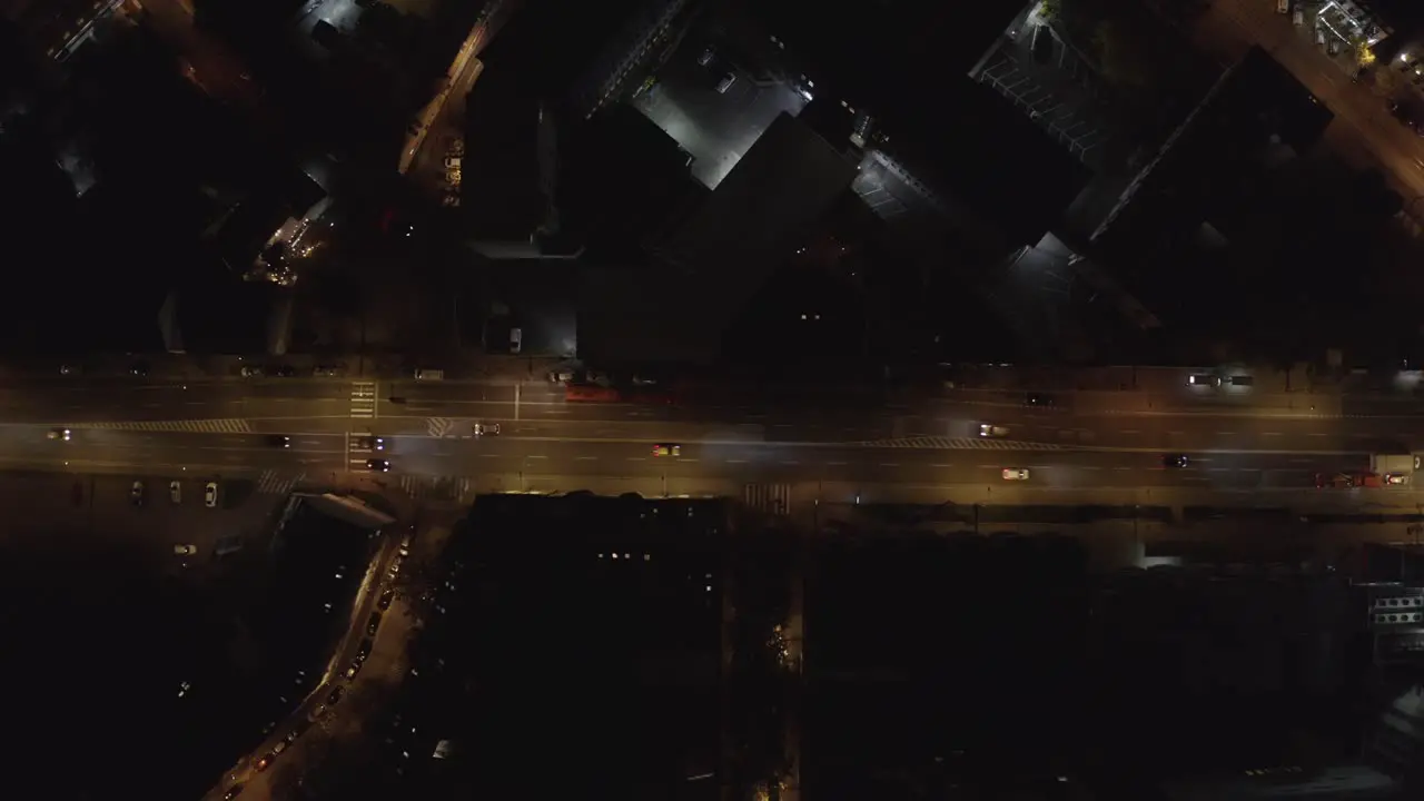 Light Traffic on Asphalt Road in City at Night Aerial top down view