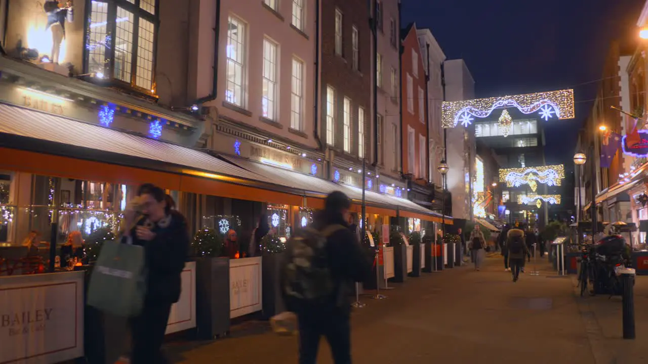 Pan shot in city center shopping area with Christmas decorations Dublin Ireland