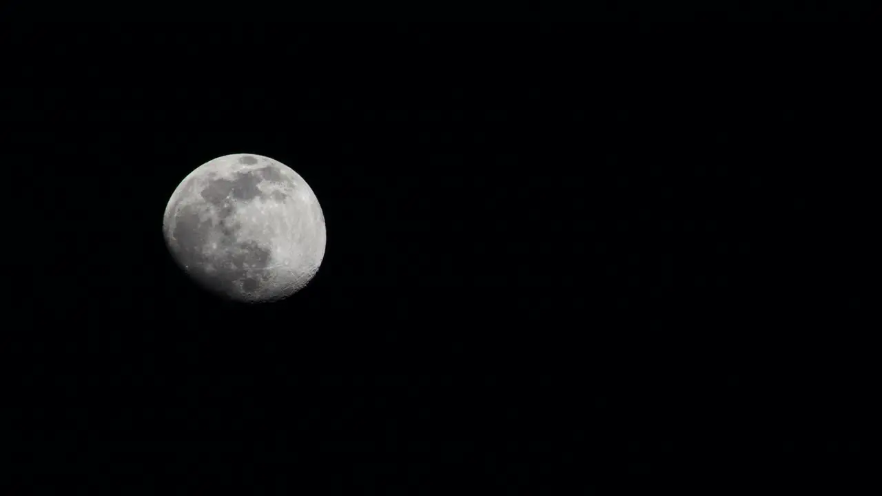 Slow time lapse of the full moon across the deep dark night sky