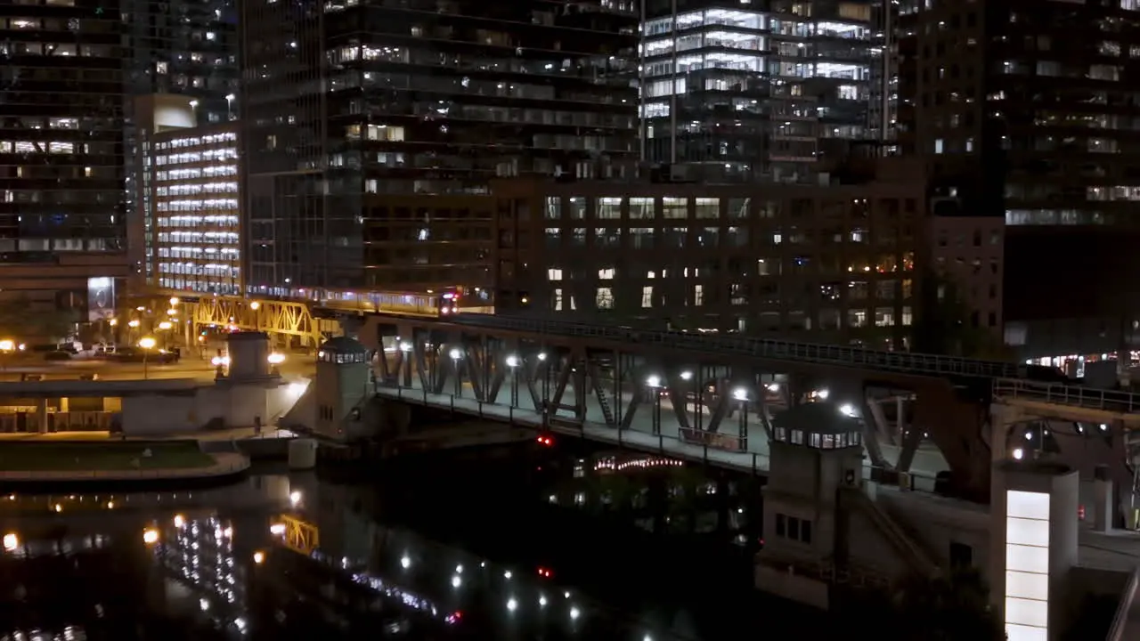 Train moving over the illuminated Lake Street Bridge night in Chicago USA