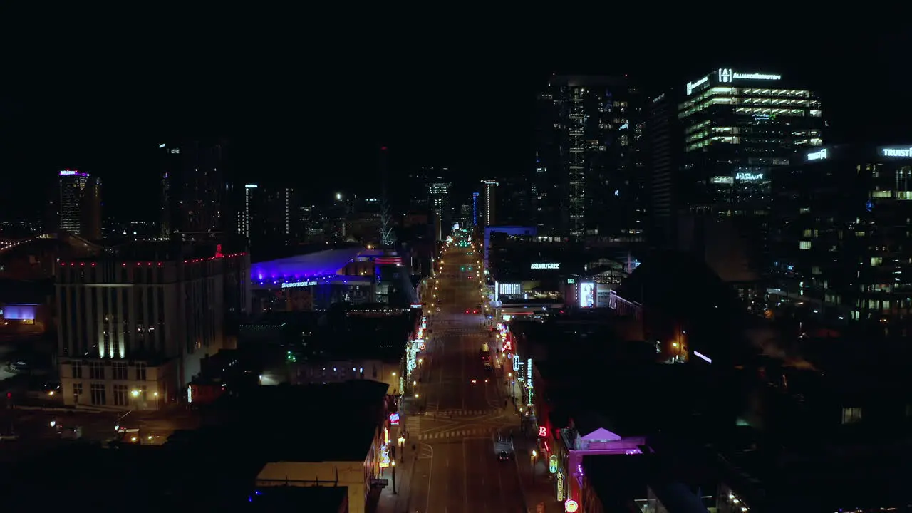 Aerial moving over empty downtown Nashville TN Broadway at night Drone 4K