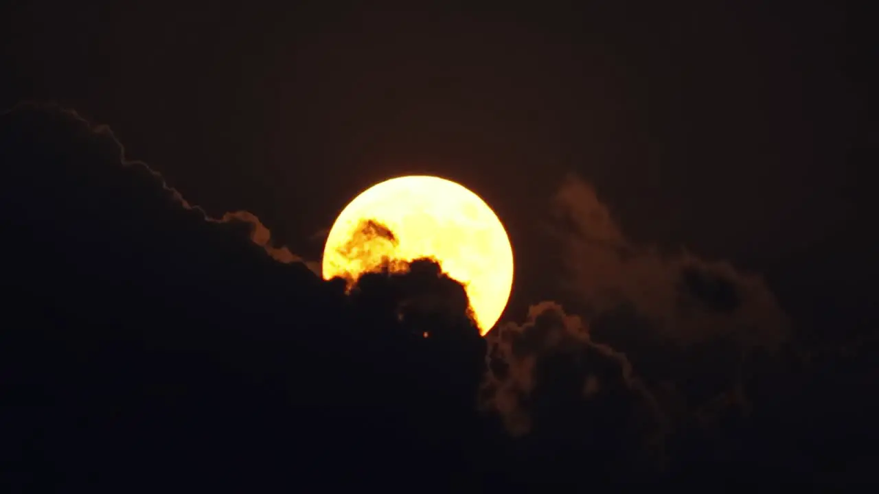 Full moon in the night sky among the clouds