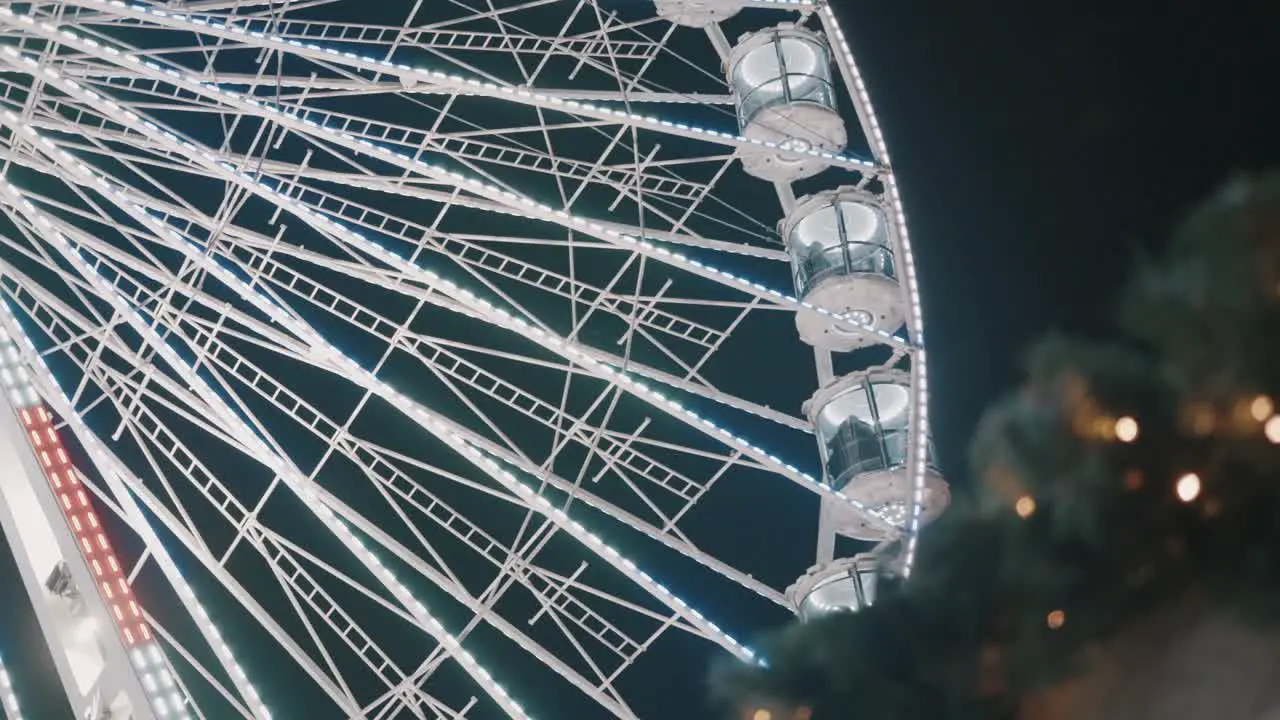 LED light illuminated ferris wheel at Christmas market in Maastricht night time holiday attraction