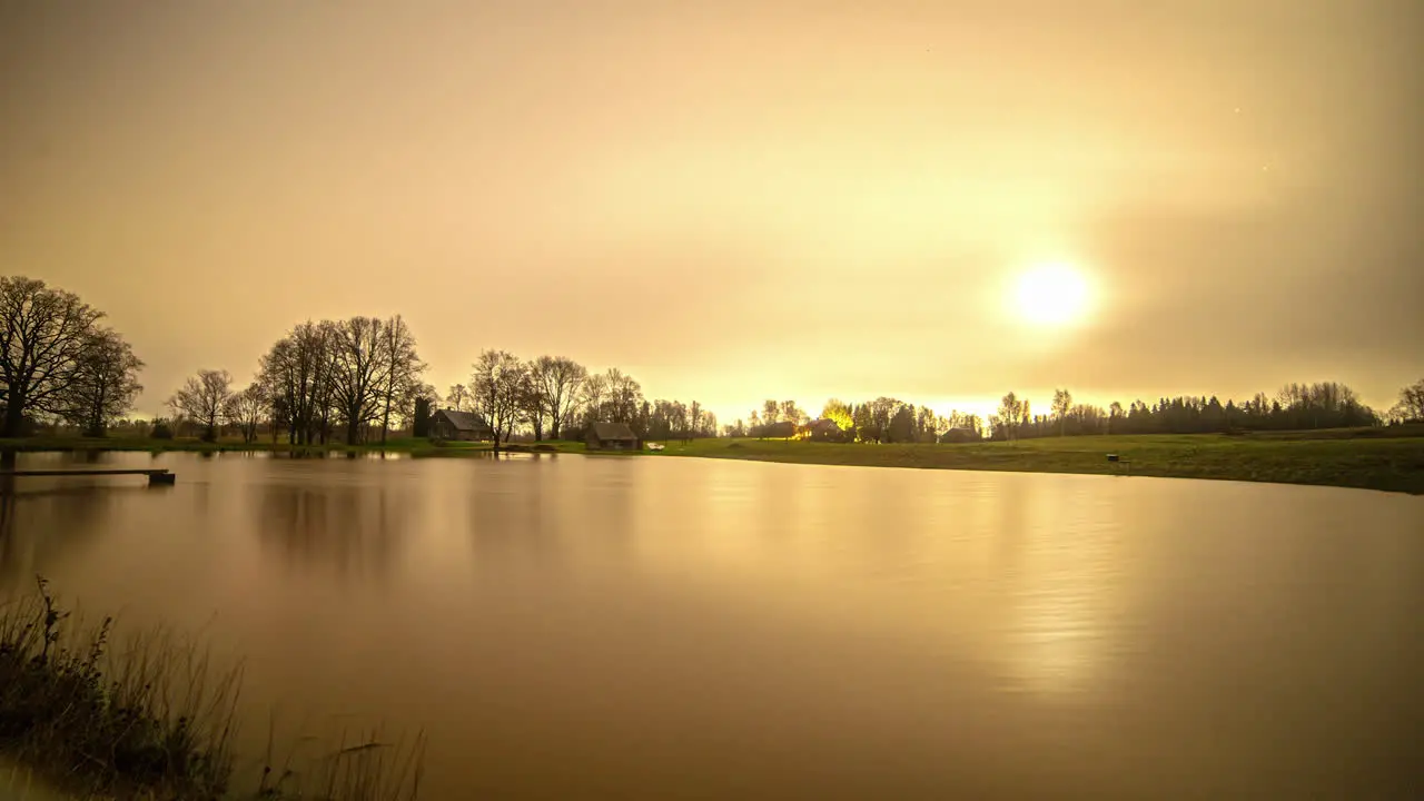 Time lapse shot of flying stars and bright rising moon at night illuminating nature lake Twilight shot until morning Nature scene