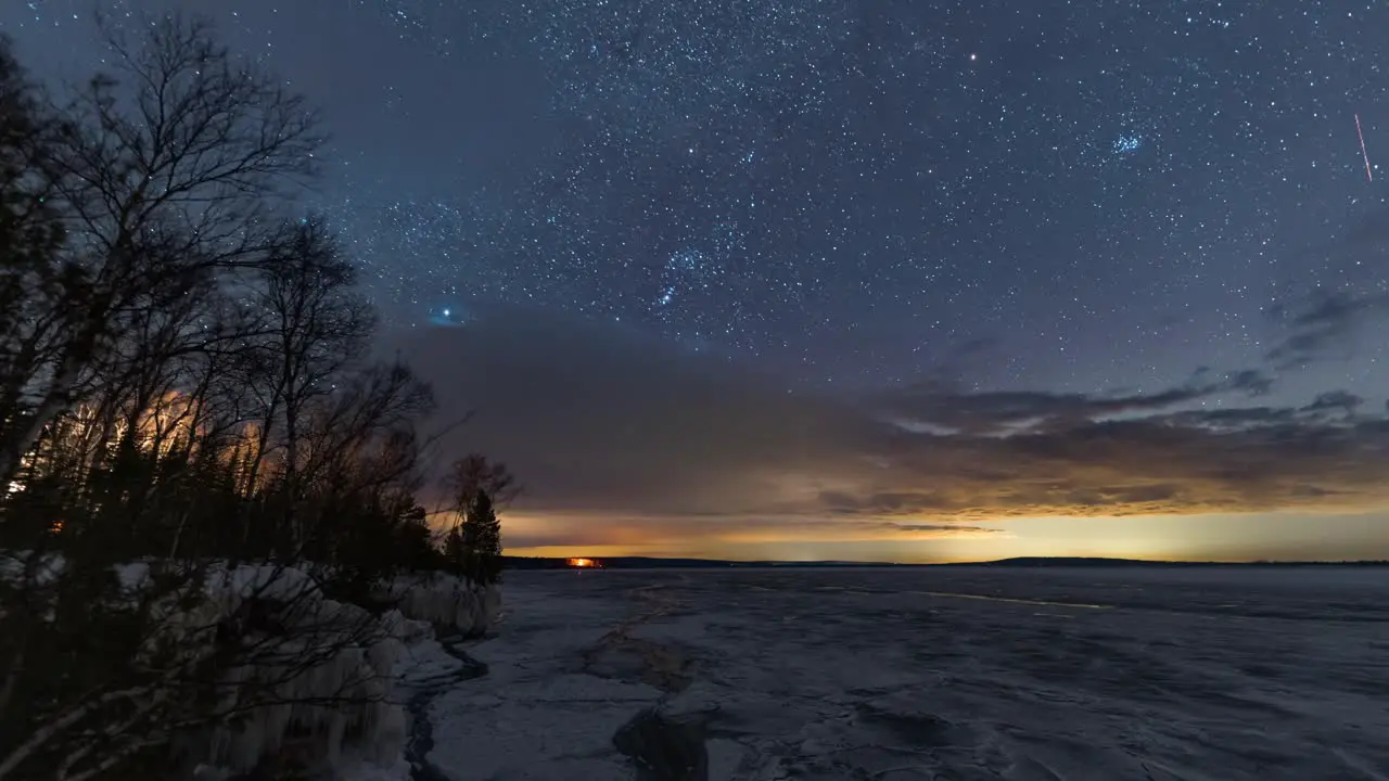 Holy grail star scape timelapse at a frozen lake transition from night to sunrise