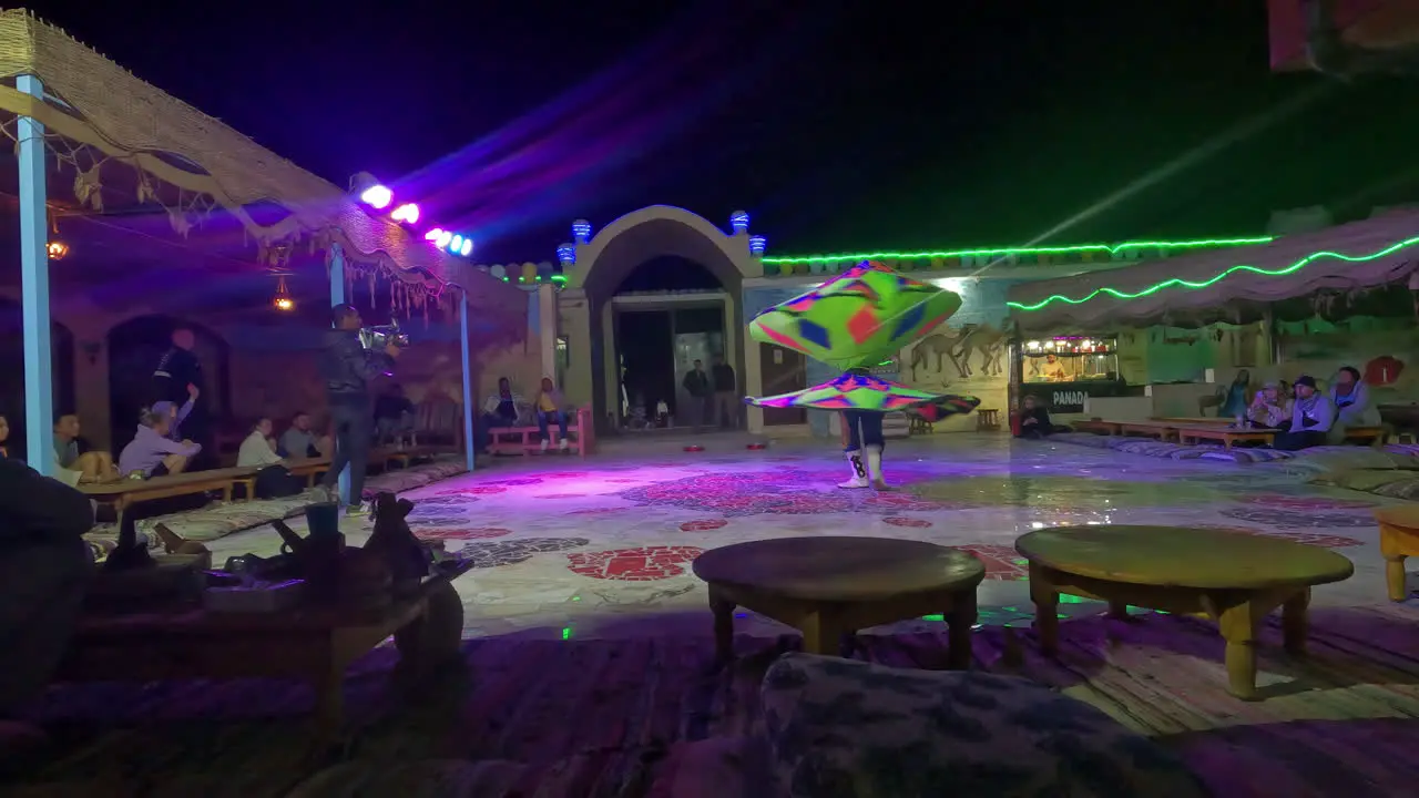 Shot of an Egyptian man circling with skirt dance for tourists in Egypt at night time