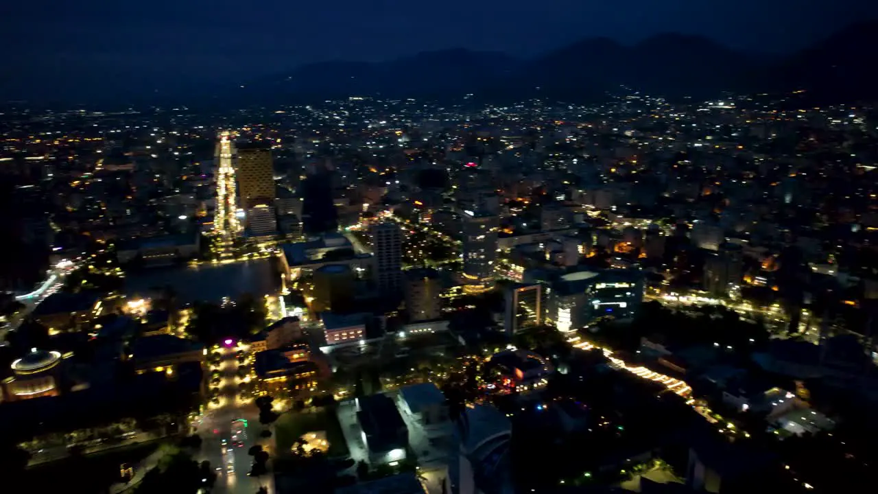 Tirana by night aerial view of panoramic capital city with high buildings museum stadium pyramid and boulevard lights