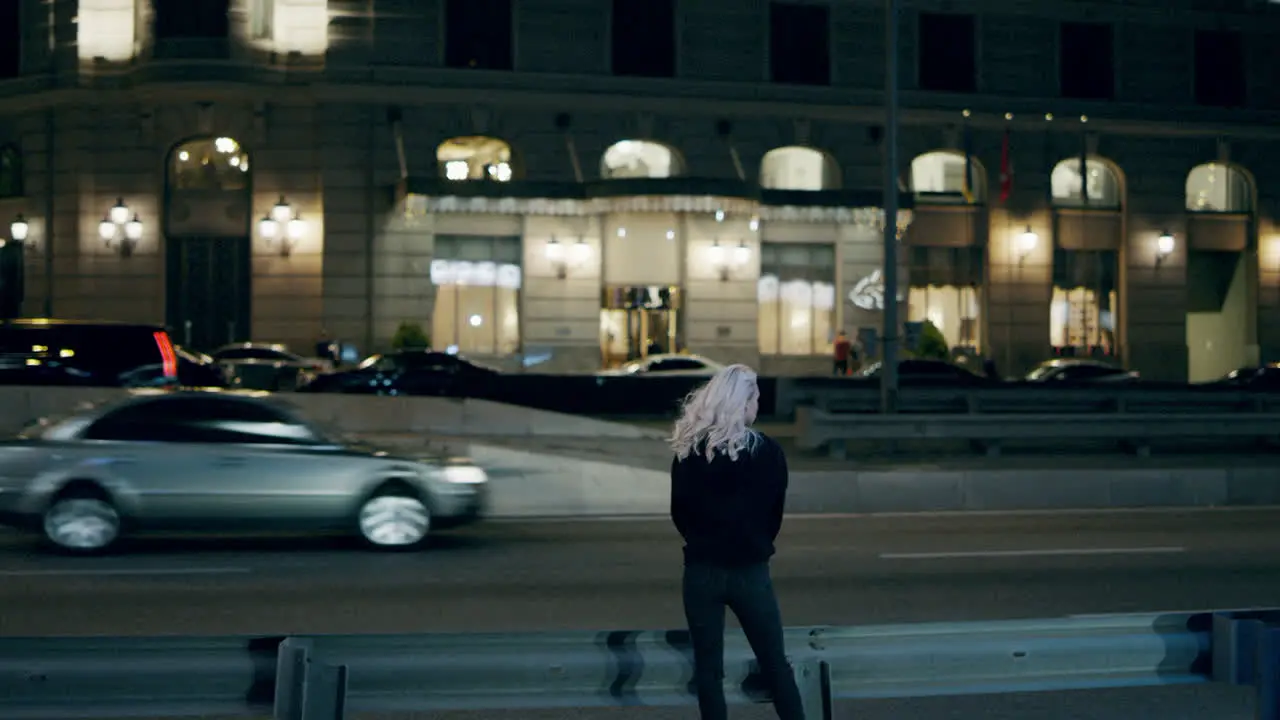 Woman standing highway night wearing urban wear in city centre