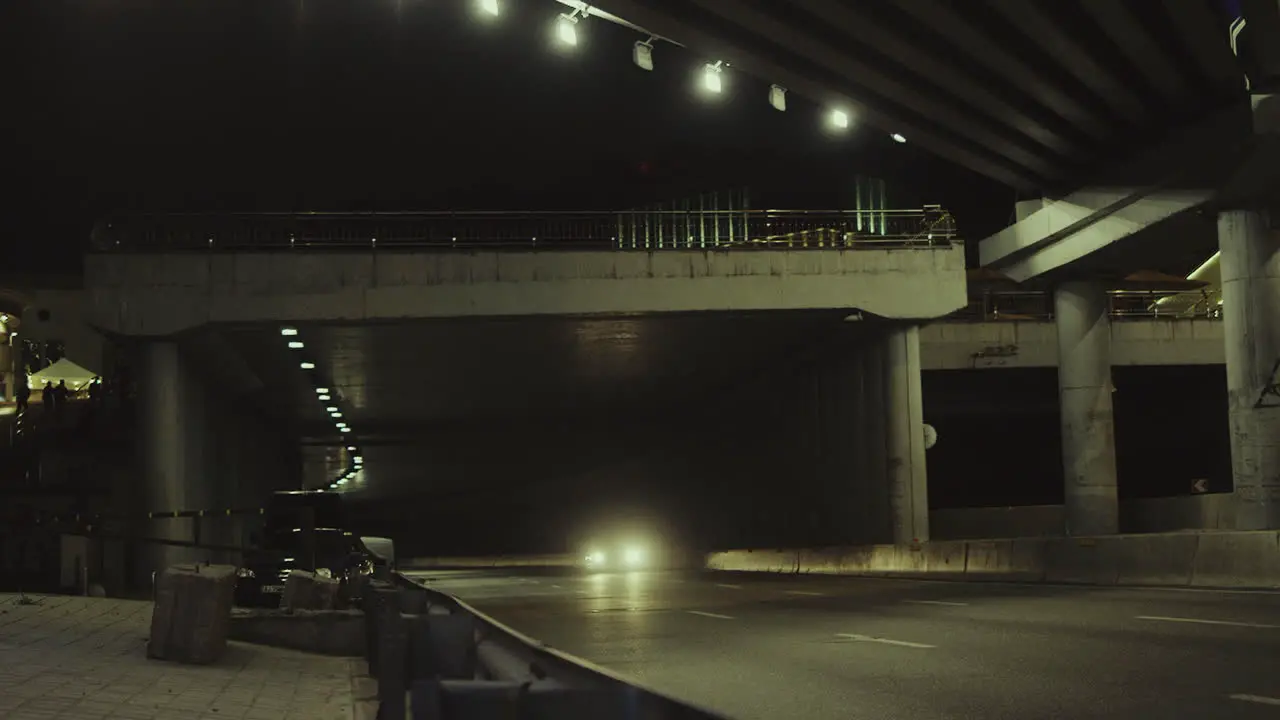 City bridge night cars passsing underground tunnel in urban background