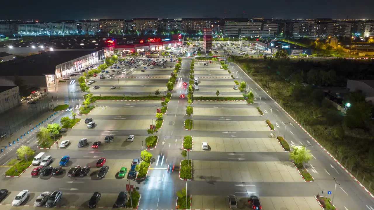 Drone night hyperlapse of car traffic in parking lot Militari Shopping Bucharest