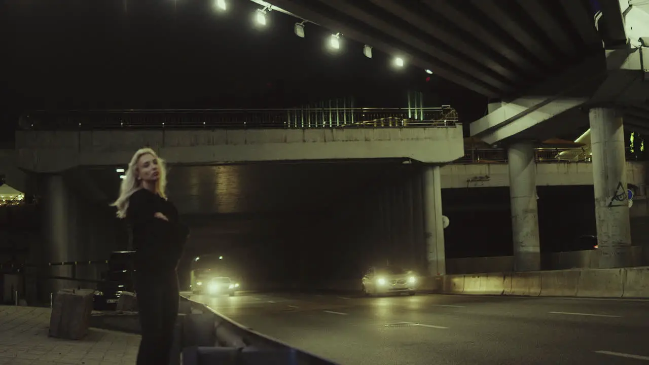 Alone girl standing highway looking at cars passing through driving tunnel