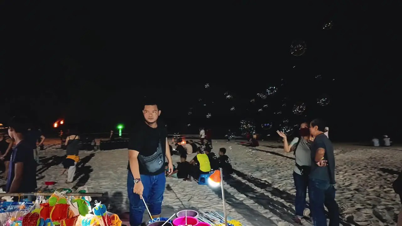 people joyfully experiencing the serene beauty of Langkawi's Pantai Cenang beach at night