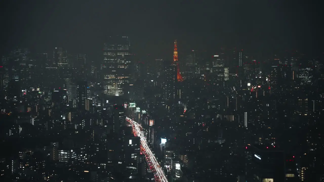 Fog Over Tokyo Skyline With Distant View Of Tokyo Tower At Night high angle hyper lapse