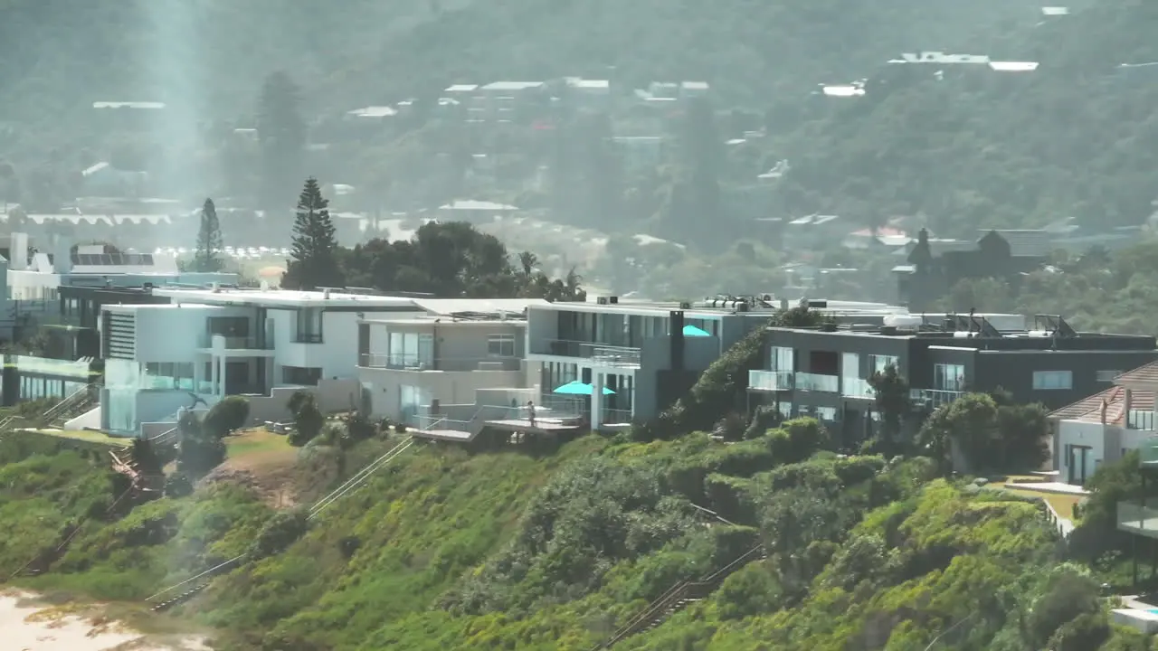 Imágenes De Diapositivas Y Panorámicas De La Hilera De Casas Elevadas Sobre La Playa De Arena Que Conduce A Lo Largo De La Costa Del Mar Sudáfrica