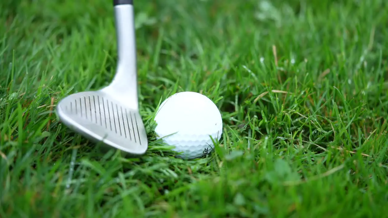 Slow motion golf ball being hit out of the rough