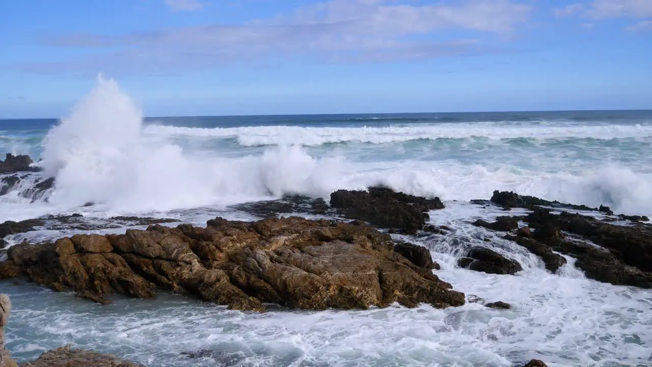 Rough ocean waves breaking onto rocky coastline in South Africa