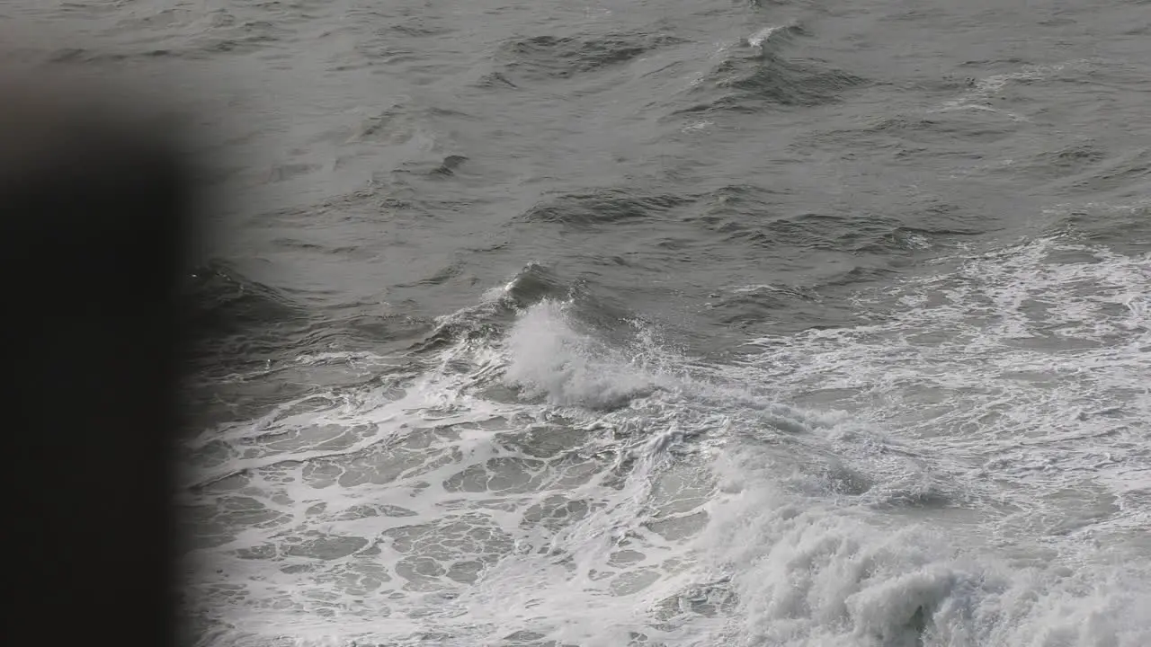 Waves crashing against rough shoreline