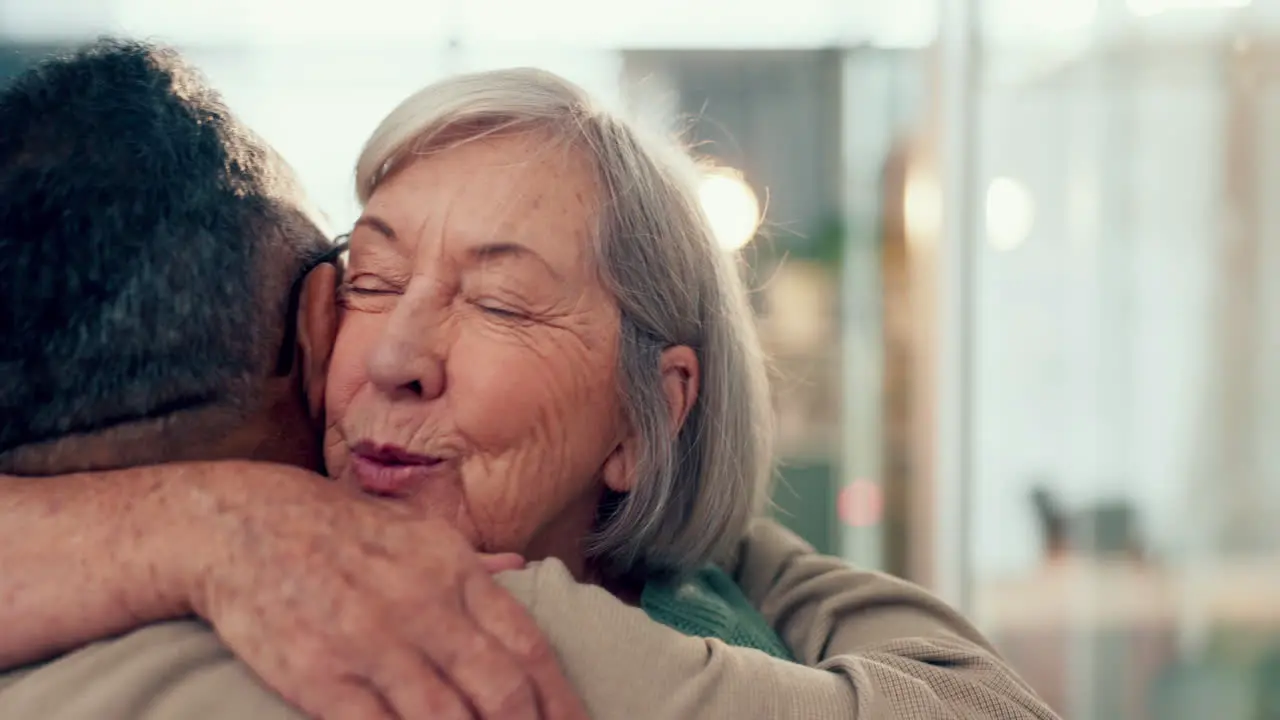 Love hug and an elderly couple in their home