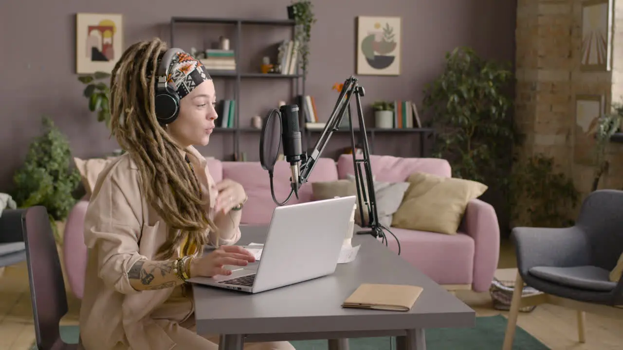 Woman With Dreadlocks Recording A Podcast Wearing Headphones