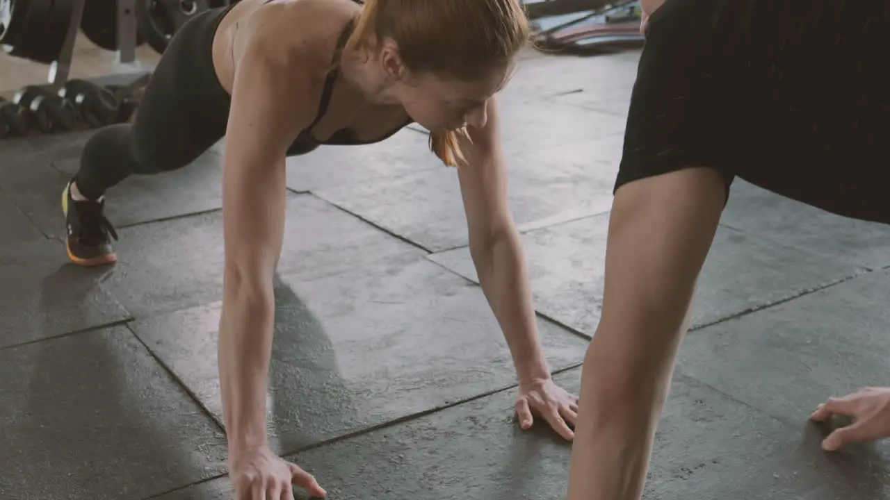 A Strong Woman And An Athletic Man Do Abdominal Exercises