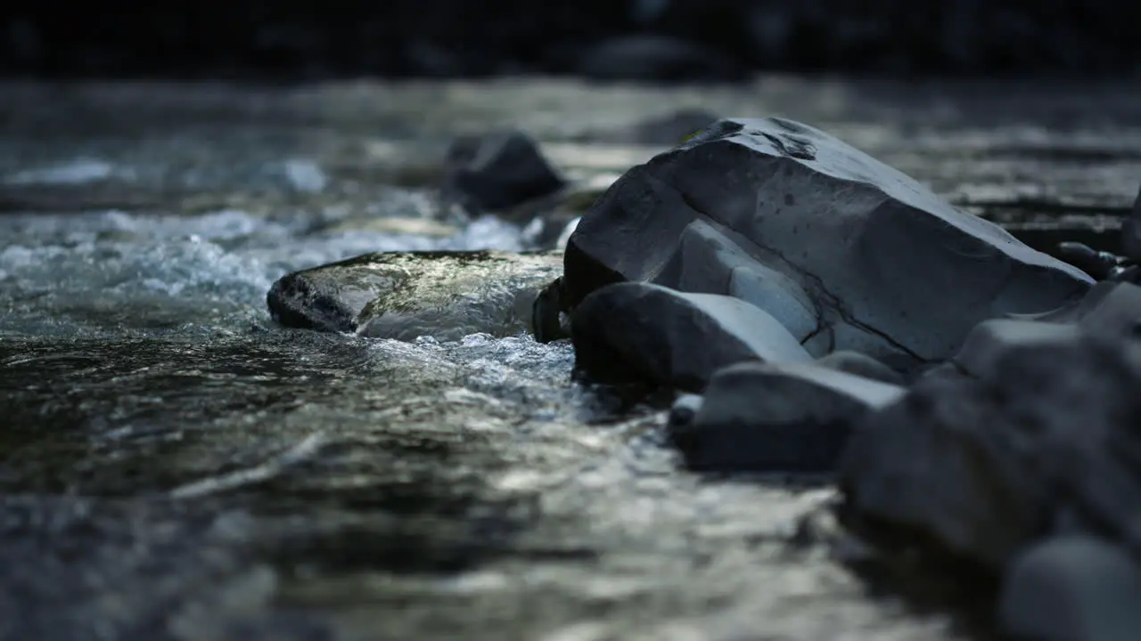 Mountain river flowing in slow motion Water stream running on rocky bottom