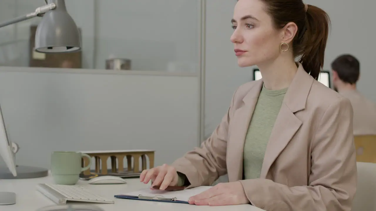 Woman Working Using Laptop Sitting At Desk In The Office