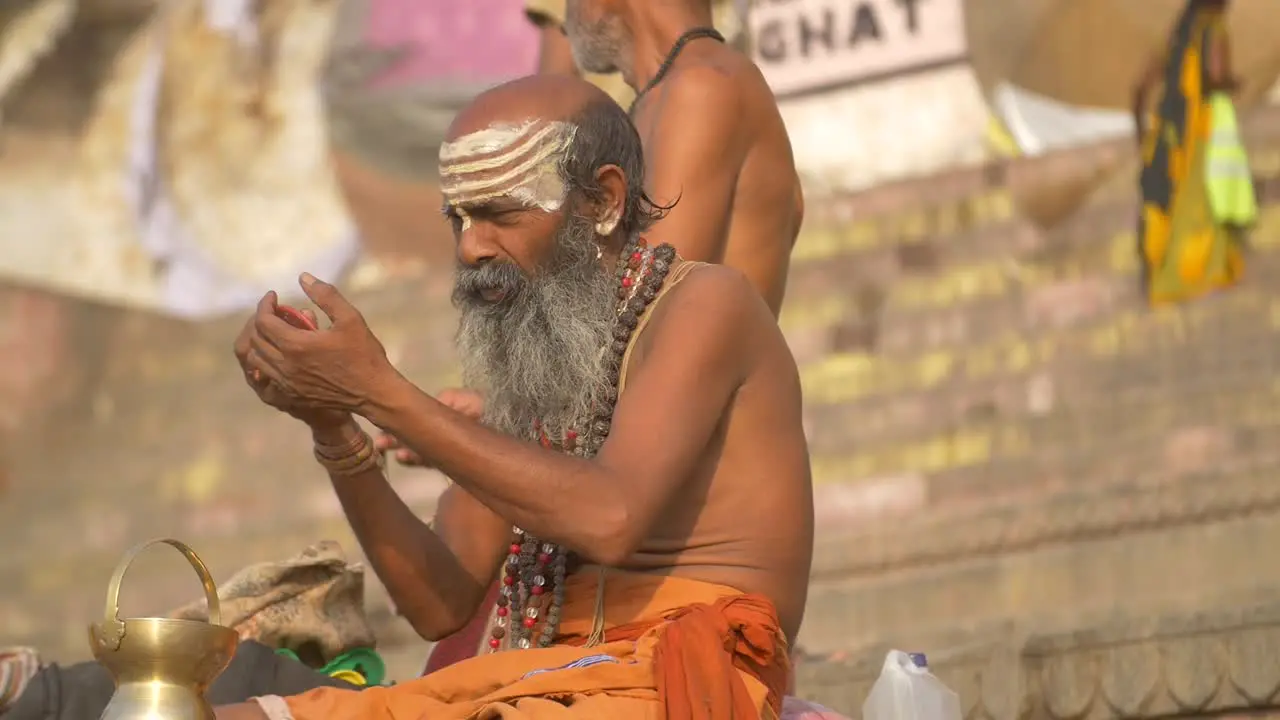 Reveal Shot of Sadhu Painting Face