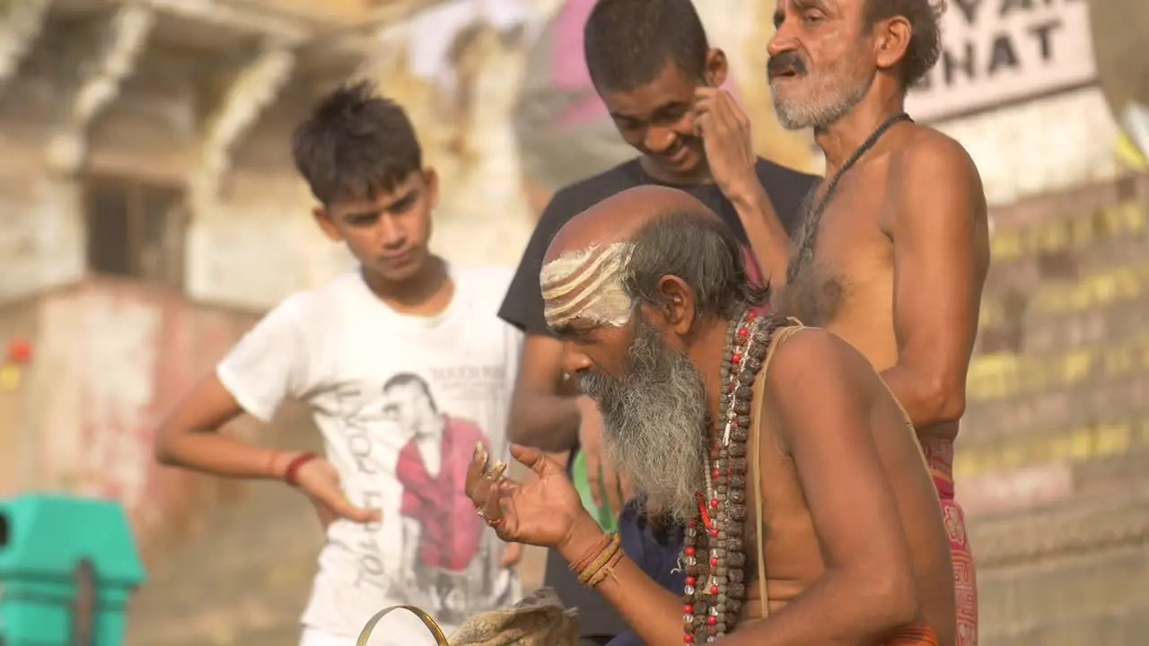 Sadhu Applying White Paint to His Nose