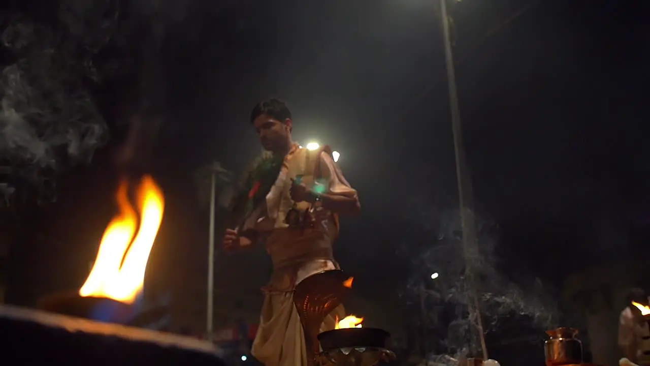 Man Performs Ganga Aarti Ceremonial Gestures