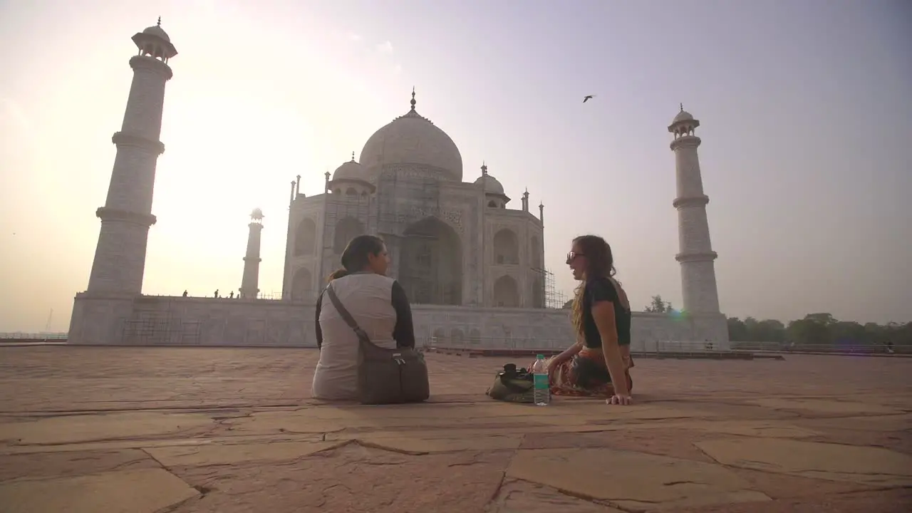 Two Women Sitting by the Taj Mahal