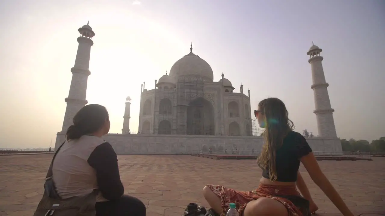 Reveal Shot of Tourists Looking at Taj Mahal