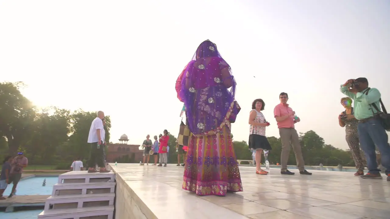 Man Taking a Photo of a Couple at the Taj Mahal